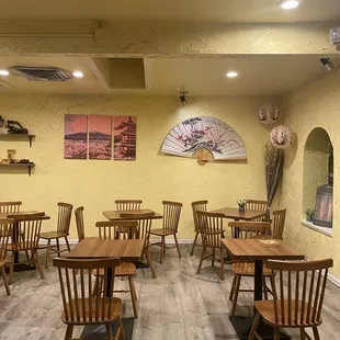 a restaurant with wooden tables and chairs