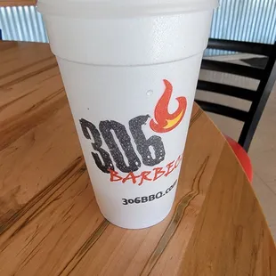 a plastic cup with a straw on a table