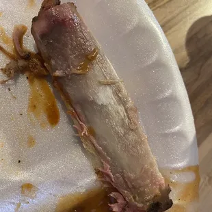 a piece of meat on a paper plate