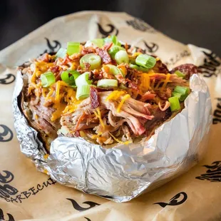 Loaded Potato topped with butter, sour cream, cheddar cheese and chives