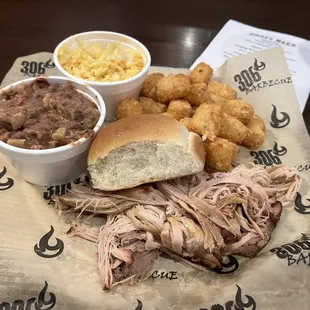 Pork plate with sides of red beans and rice, spicy (nasty) coleslaw, and tater tots.