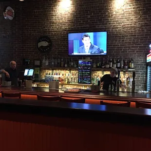 two men sitting at a bar