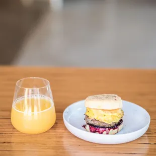 a sandwich and a glass of orange juice