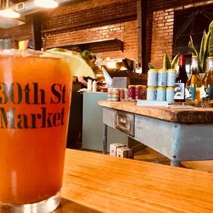 a glass of beer on a bar