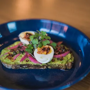 an avocado toast with hard boiled eggs