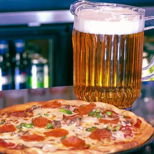 a glass of beer and a pizza