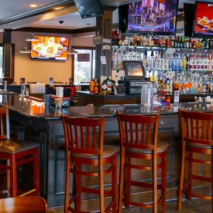 a bar with a lot of chairs