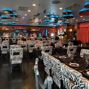 tables and chairs with zebra print covers
