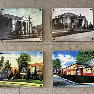 a brick wall with four old postcards on it