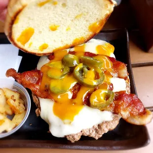 Nap Town Turkey burger with bacon, Swiss cheese, jalapeños, pineapple (seen on the side) and mustard- based bbq sauce