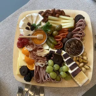 10x10 board with dried up orange , grapes that are soft and brown spots all over them. The 2 hard cheeses were dried out