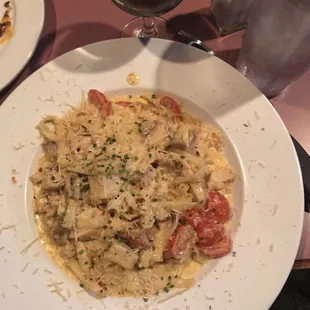 a plate of pasta and a glass of wine