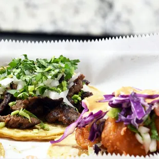 two tacos with meat and vegetables