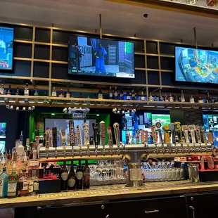 a bar with multiple televisions