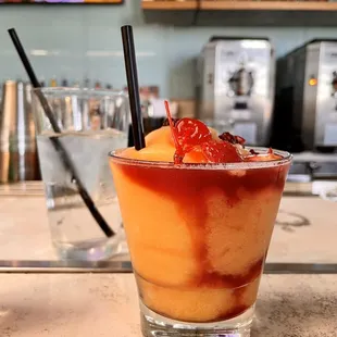 a drink in a tall glass on a bar