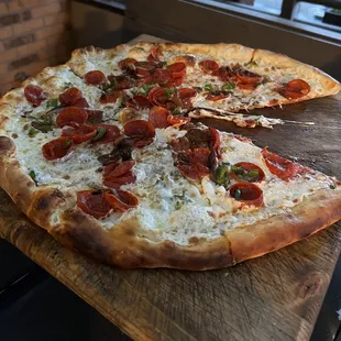 a pepperoni pizza on a cutting board