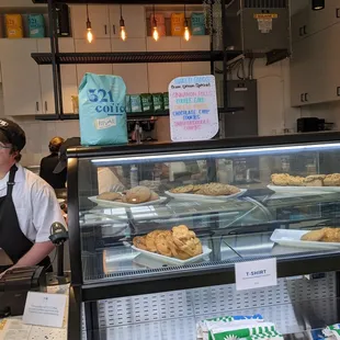 a woman behind the counter of a coffee shop