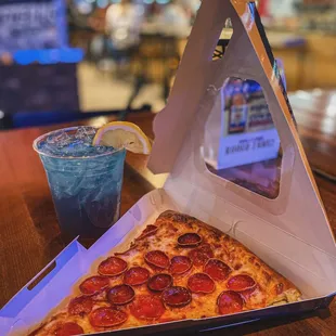 Enjoy the magic of Vegas nights with a perfectly baked pepperoni pizza slice and an icy cocktail that's as cool as the city lights.
