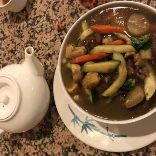 a bowl of soup and a teapot