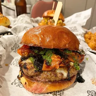 a burger on a bun with cheese and broccoli