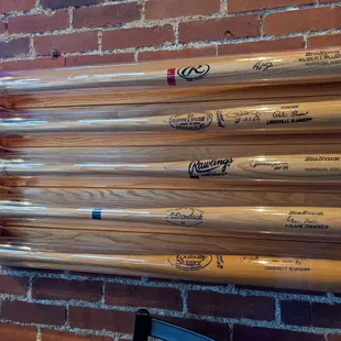 baseball bats mounted on a brick wall