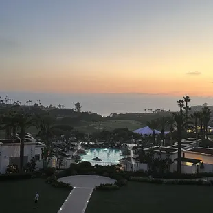 a view of a resort at sunset