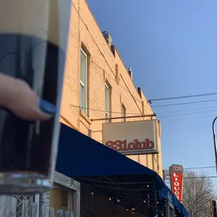 a hand holding a pint of guinness