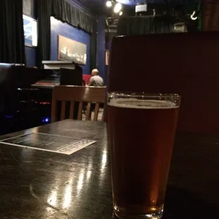 a pint of beer on a table