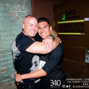 two men hugging each other