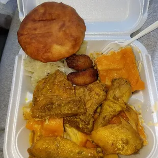 Curry Chicken, cabbage, plantains, baked Mac and cheese, and johnny cake