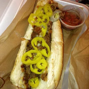 a hot dog with peppers and onions