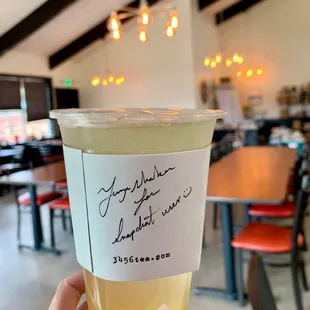 a person holding a cup of tea