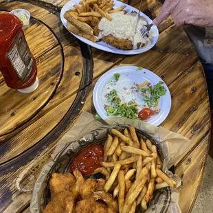two plates of food on a wooden table