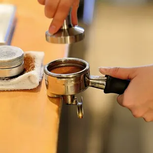 a person using a coffee grinder