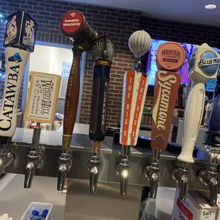 a row of beer taps in a bar