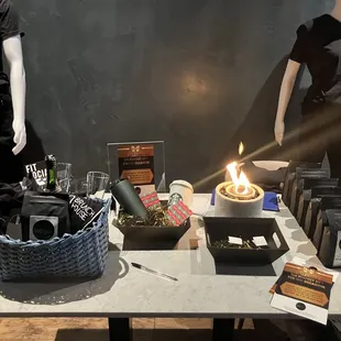 two mannequins and a table with items on it