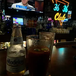 a beer and a glass on a bar
