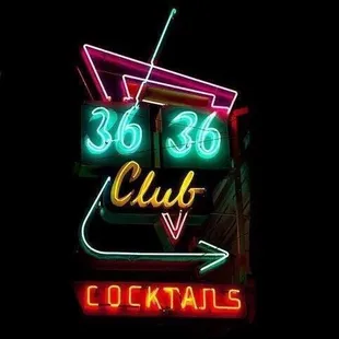 a neon sign for a cocktail bar