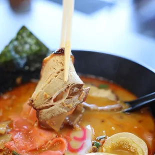 a bowl of ramen and chopsticks