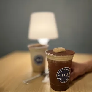  a hand holding a cup of coffee