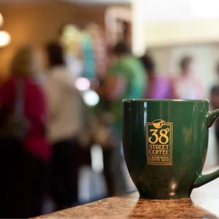 a green coffee cup on a counter