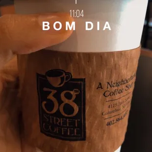 a hand holding a cup of coffee