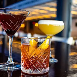 two cocktails on a bar