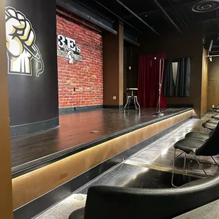 a stage with chairs and tables