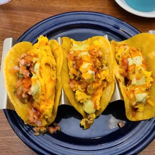 three tacos on a blue plate