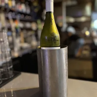 a bottle of wine in a silver cup