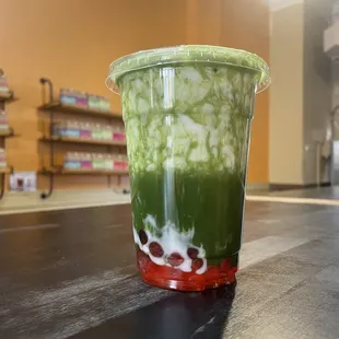 a cup of green tea on a table