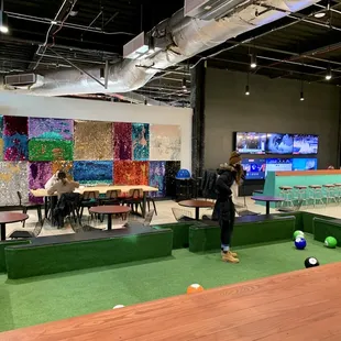 a woman playing a game of mini golf