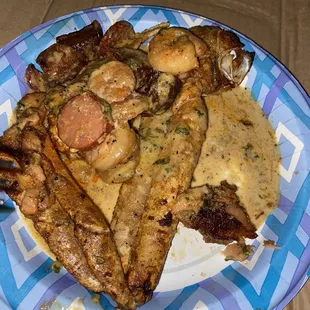 Crab legs, sausage, potatoes, salmon, and shrimp