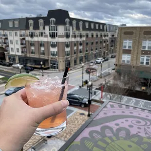 a hand holding a drink